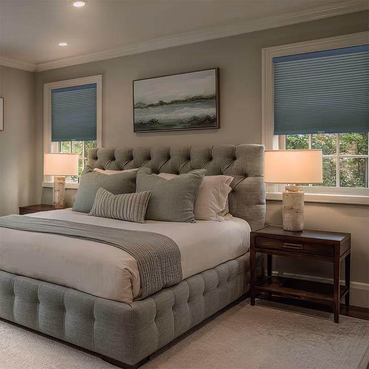 Honeycomb cellular shades on a bedroom window on a bright winter morning in Toronto