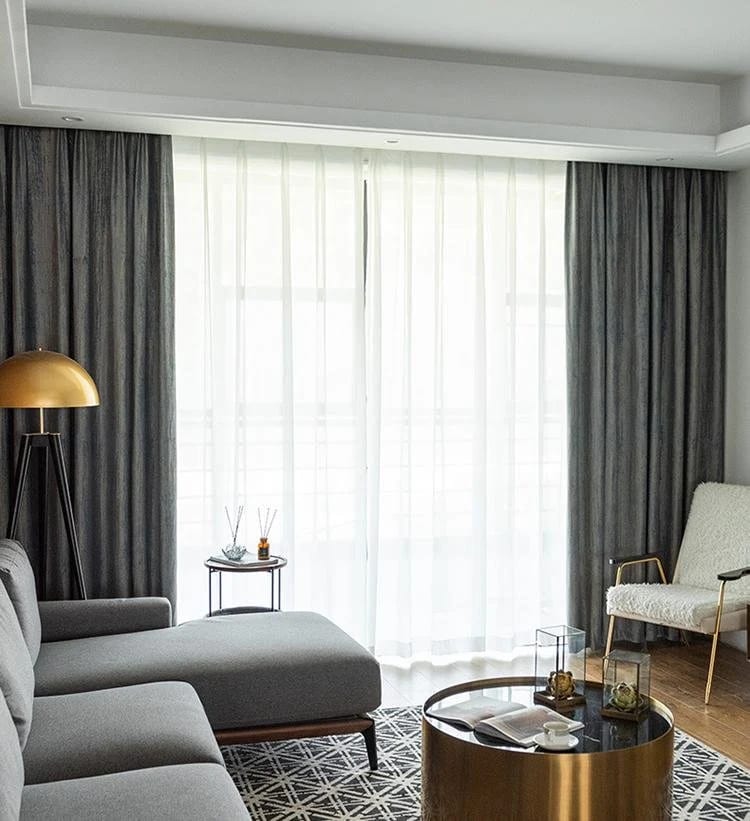 Charcoal curtains layered over a white sheer across a wall of glass doors