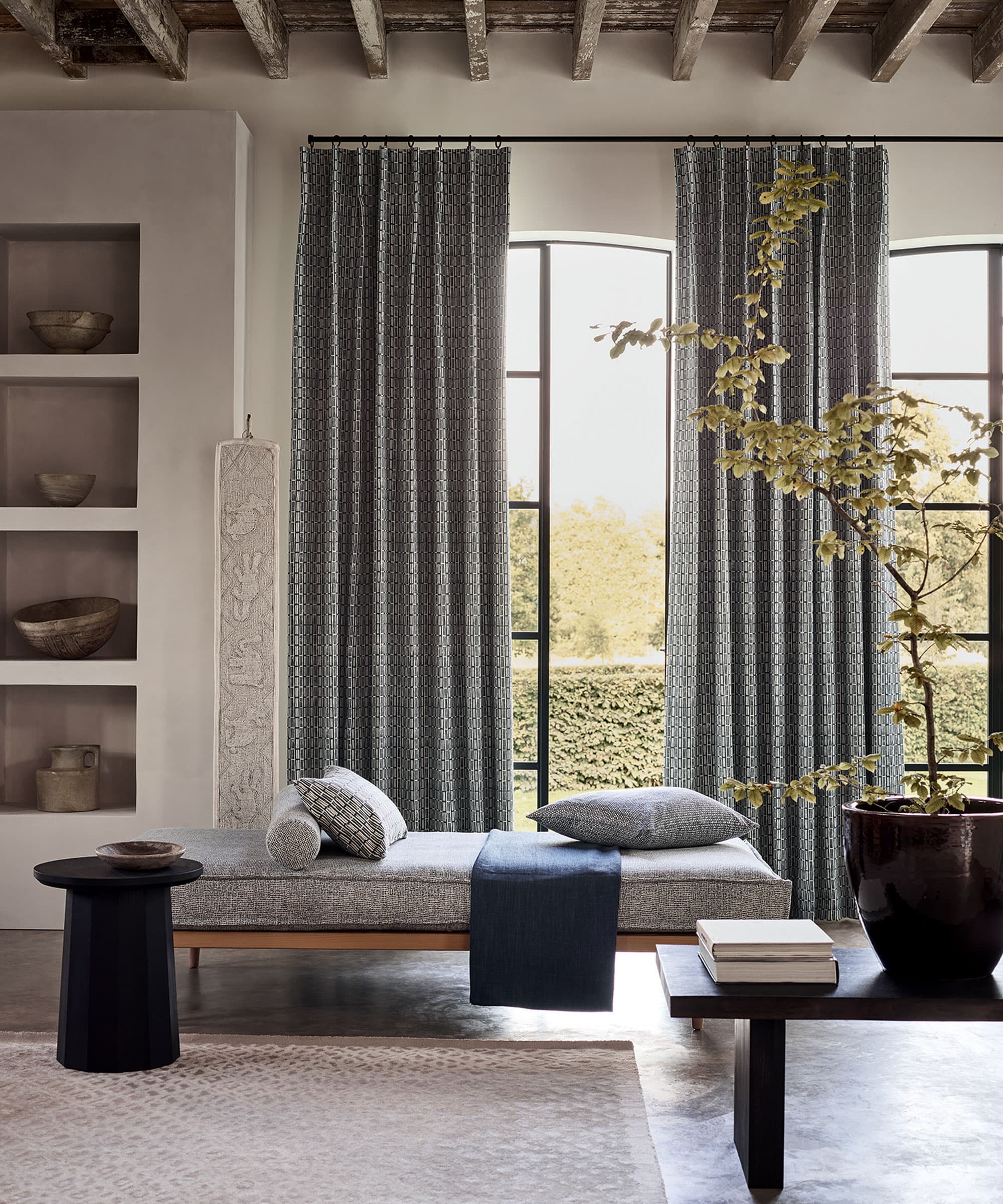 Floor length linen curtains on a motorized track beside a tall Toronto window
