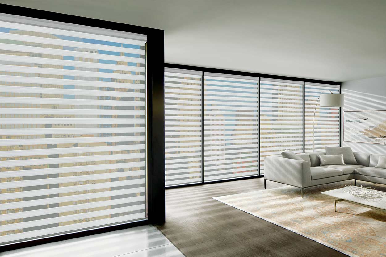 Zebra shades half open across a wall of loft windows in Toronto